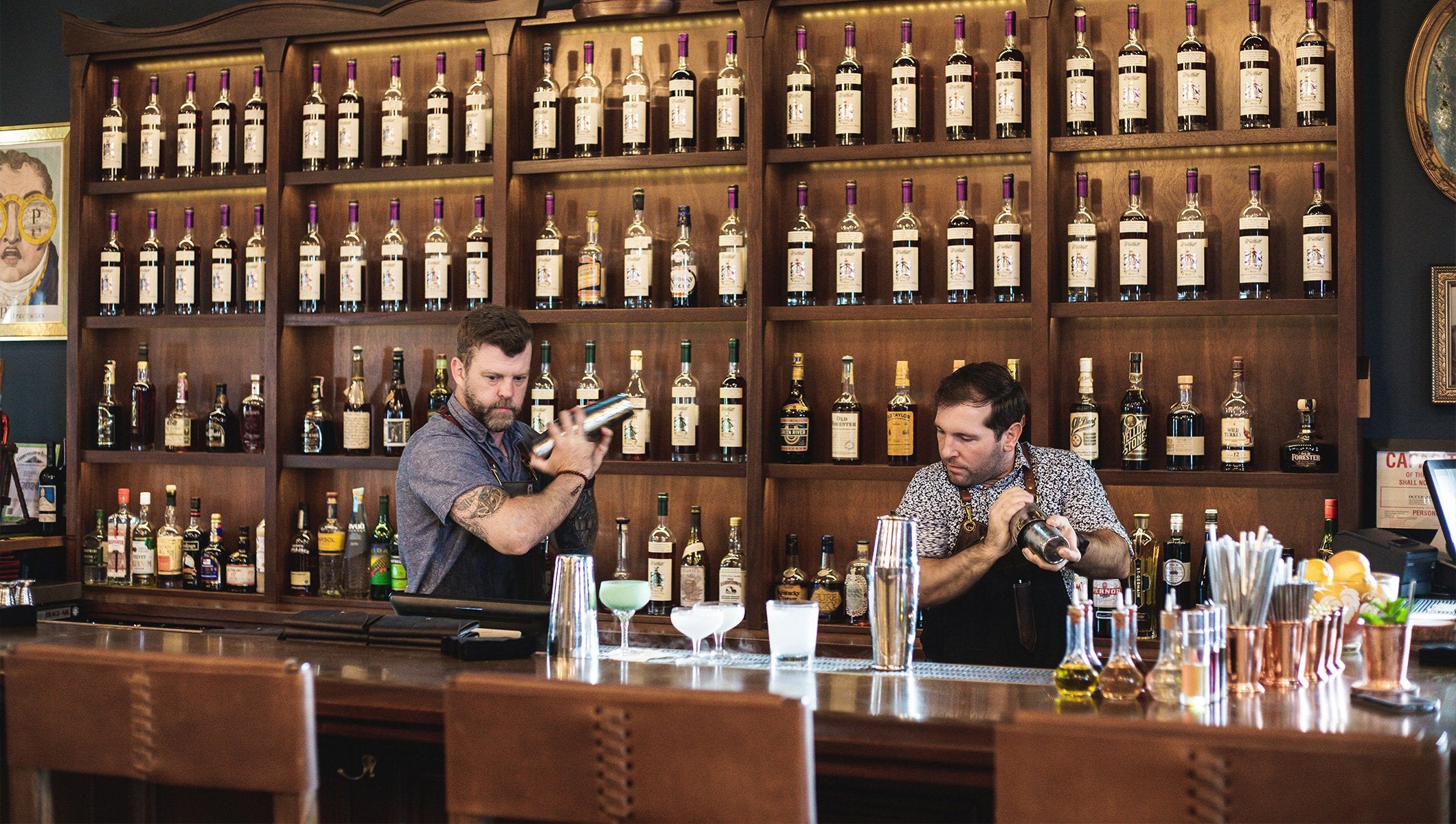Two bartenders making drinks.