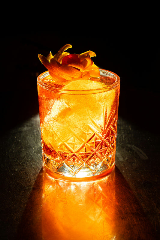 Glowing amber cocktail on the rocks.
