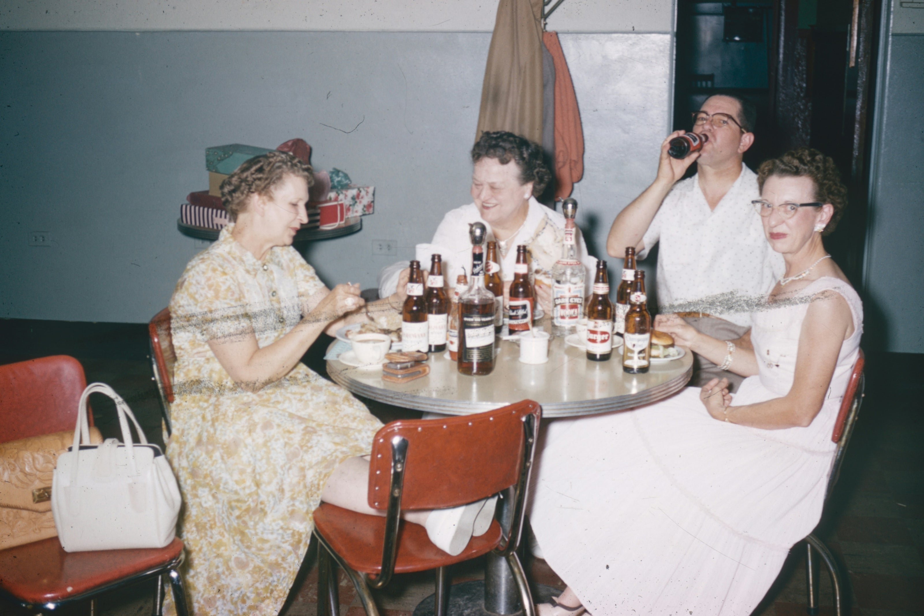 Old photo of ladies sitting at table.